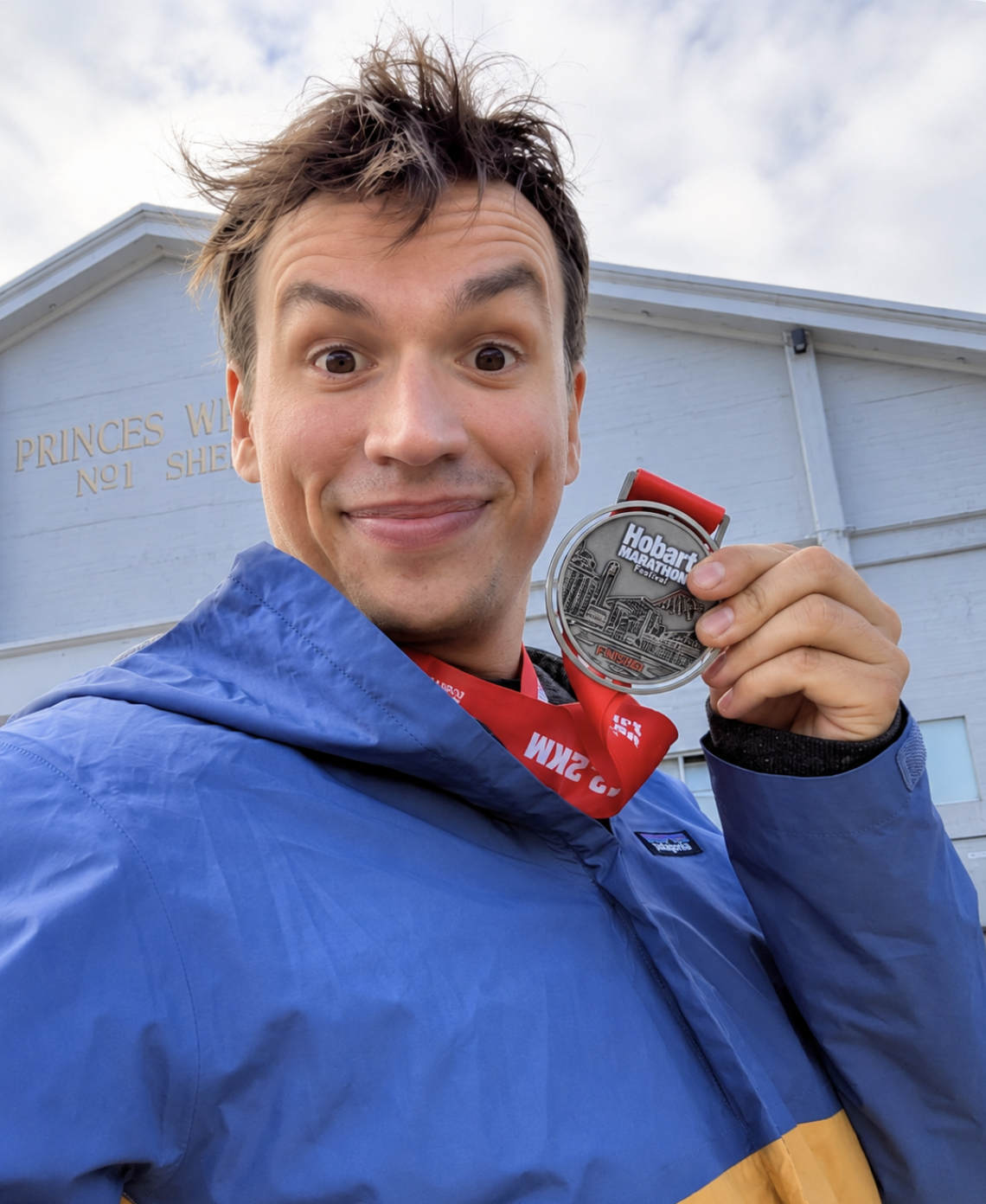 Jurek holding a Hobart Marathon medal